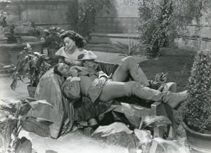 Don Juan (Errol Flynn), in the company of Donna Elena (Ann Rutherford).