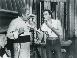 Leporello (Alan Hale) and Don Juan de Marana (Errol Flynn) attend to their morning ablutions.