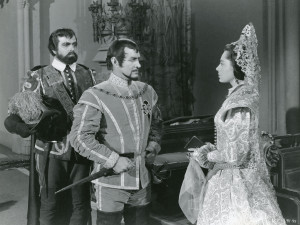 Don Rodrigo (Douglas Kennedy) and Duke de Lorca (Robert Douglas) confront Queen Margaret (Viveca Lindfors).